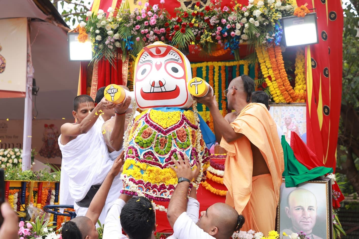 Devotees performing Arati to Their Lordships Jagannath, Baladeva and Subhadra before the procession